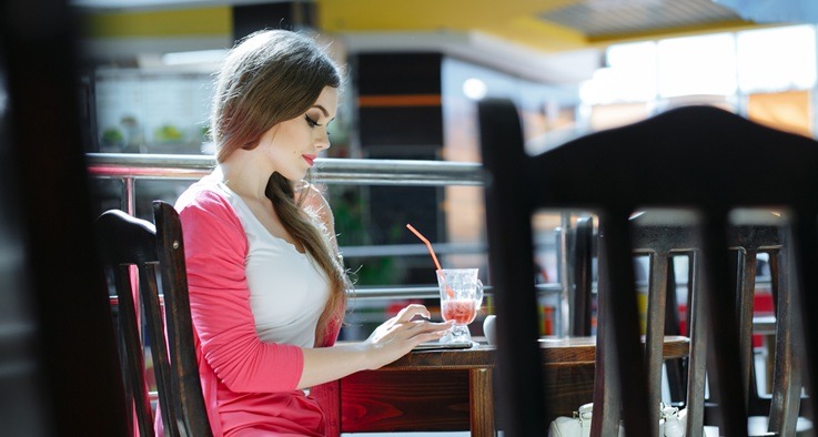 Woman sitting at a café table.
