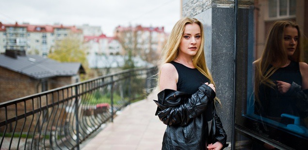 Person in black outfit outdoors.